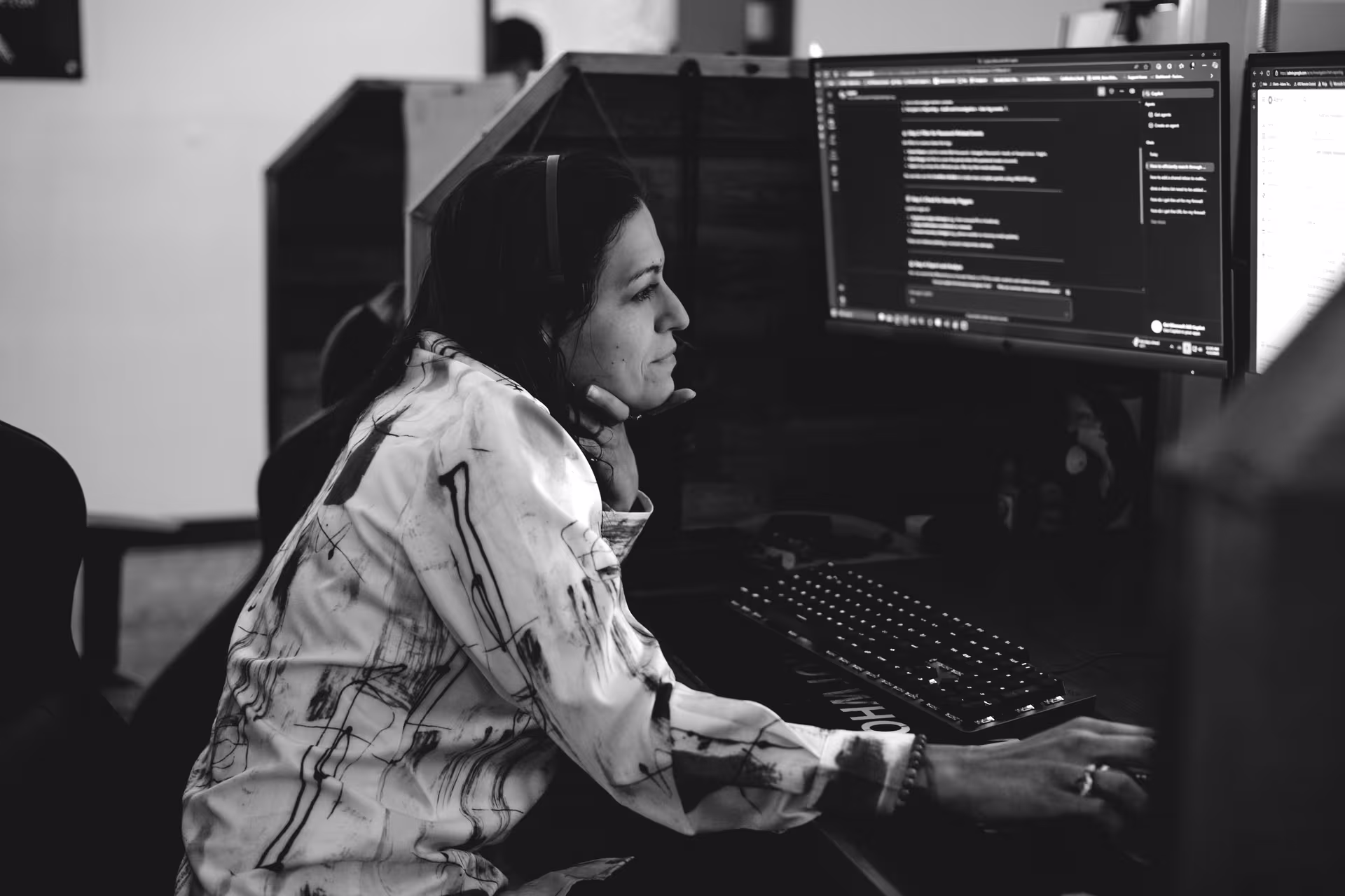 Team member working at a multi-monitor workstation